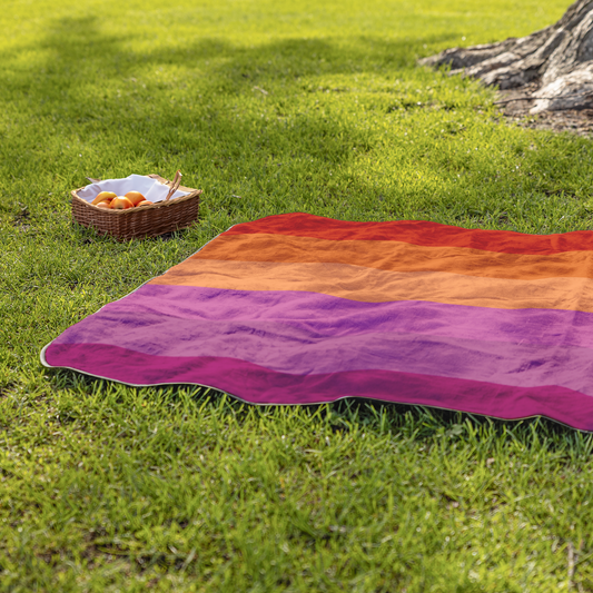 Lesbian_Pride_Stadium_Blanket_StadiumBlanket_Lifestyle_Grass_H_Mockup.png