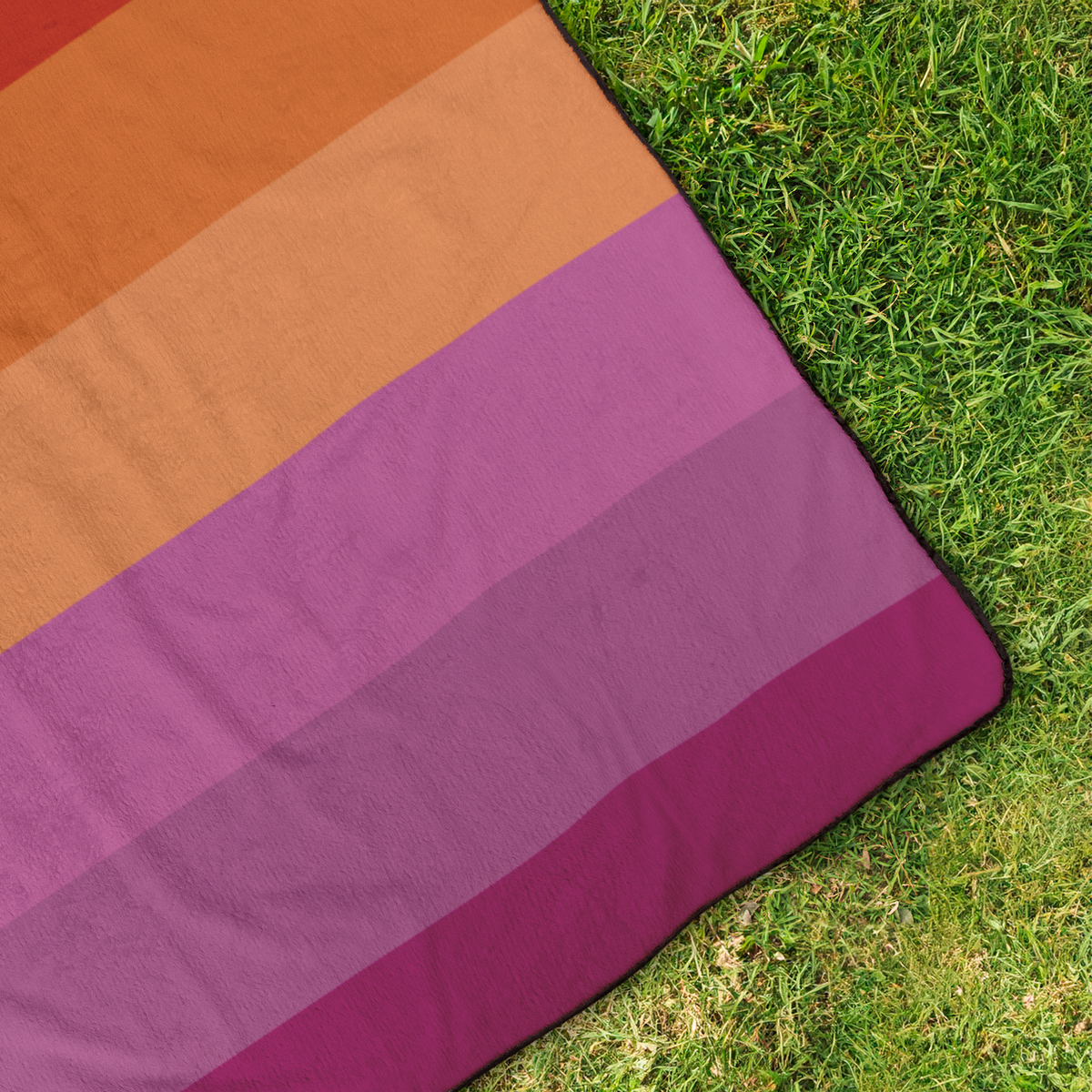 Lesbian_Pride_Stadium_Blanket_StadiumBlanket_OverheadGrass_H_Mockup.png