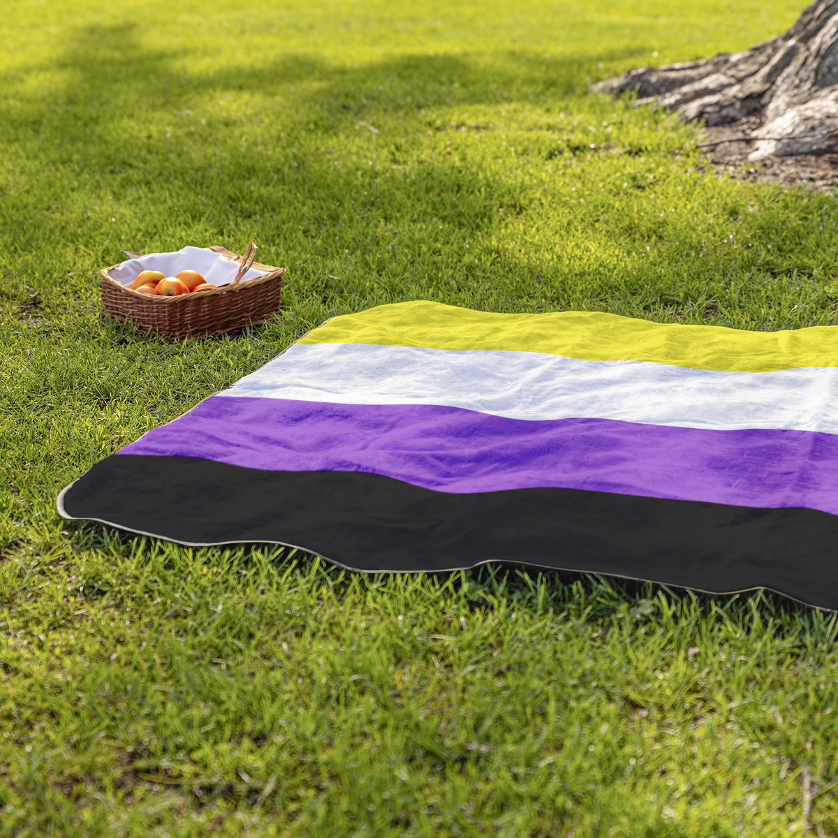 Nonbinary_Pride_Stadium_Blanket_StadiumBlanket_Lifestyle_Grass_H_Mockup.png